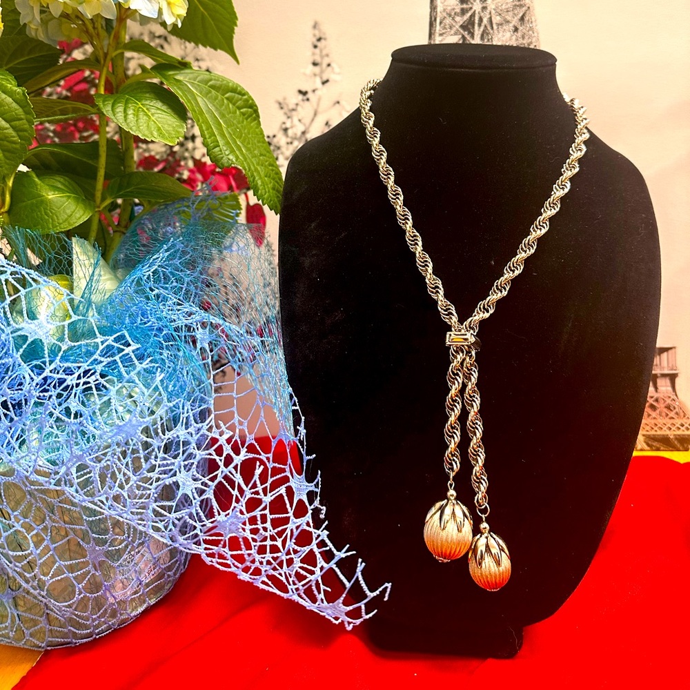 Gold tone torso with two pearls